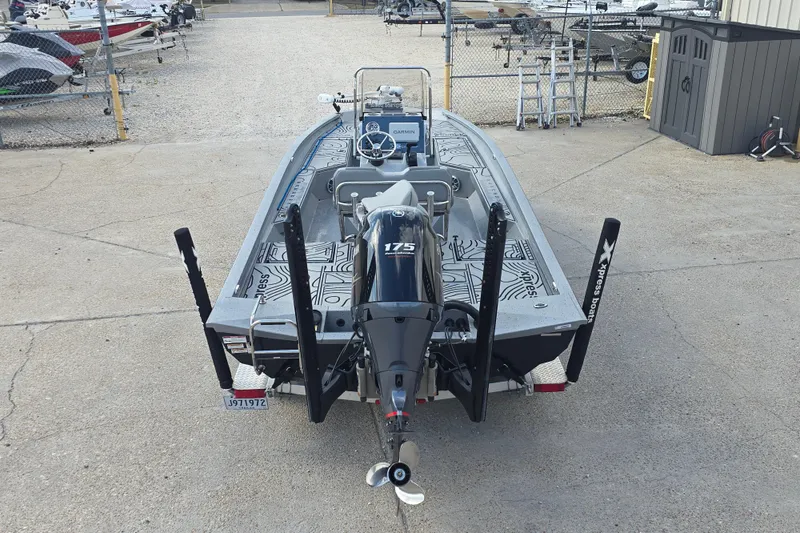 Slide: The Image of 2024 Xpress H22B Bay boat with 175 HP engine, parked in a marina. - 7