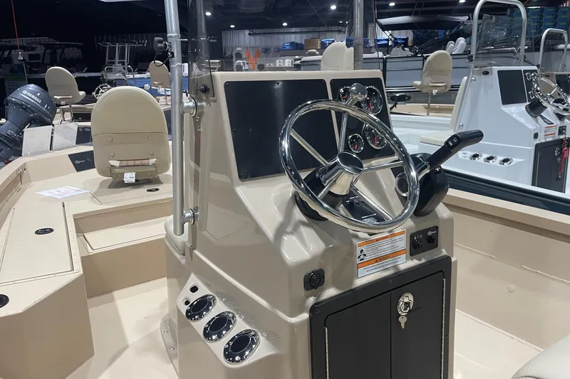 Slide: The Image of 2024 G3 Bay 20 GX boat interior with steering console and seating. - 2