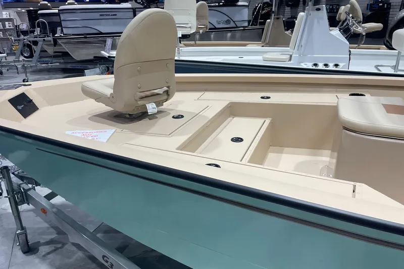 Slide: The Image of 2024 G3 Bay 20 GX boat interior with beige seating and storage compartments. - 3