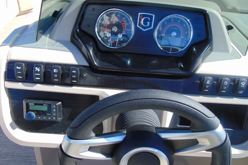 Slide: The Image of Dashboard of 2026 Godfrey SWEETWATER 2286 SFL boat with steering wheel and controls. - 14