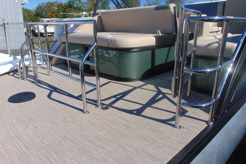 Slide: The Image of 2026 Godfrey SWEETWATER 2286 SFL pontoon boat with chrome railings and beige seating. - 4