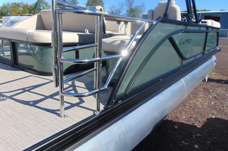 Slide: The Image of 2026 Godfrey SWEETWATER 2286 SFL pontoon boat with chrome ladder and beige seating. - 5