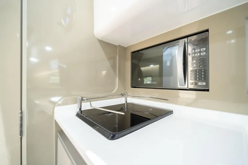 Slide: The Image of Modern kitchen in 2026 Hanover 387 RV with microwave and sleek stovetop. - 27