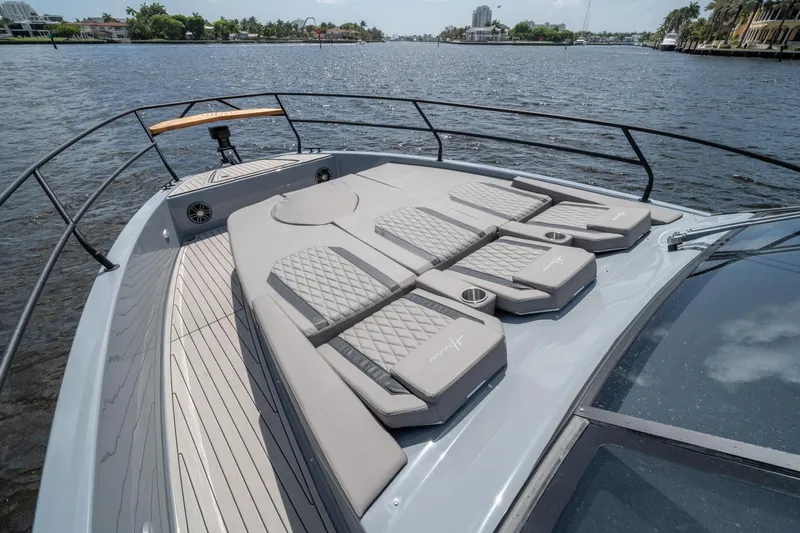 Slide: The Image of Luxurious 2026 Hanover 387 yacht deck with cushioned sunbathing area on a scenic waterway. - 8
