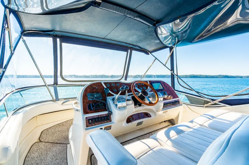 Slide: The Image of 1999 Maxum 4100 SCA Motor Yacht helm with panoramic ocean view. - 16
