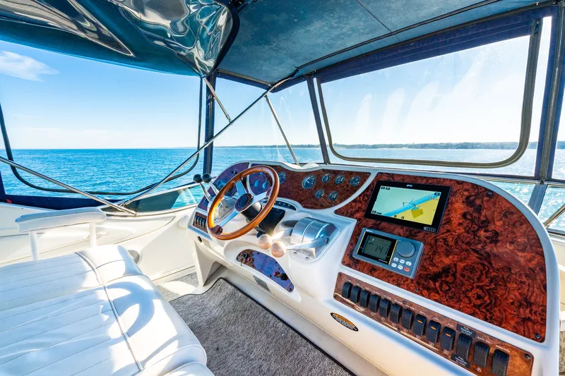 Slide: The Image of Cockpit of 1999 Maxum 4100 SCA Motor Yacht with ocean view and navigation equipment. - 19