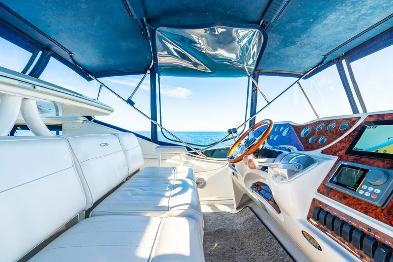 Slide: The Image of Interior of 1999 Maxum 4100 SCA Motor Yacht with modern dashboard and ocean view. - 20