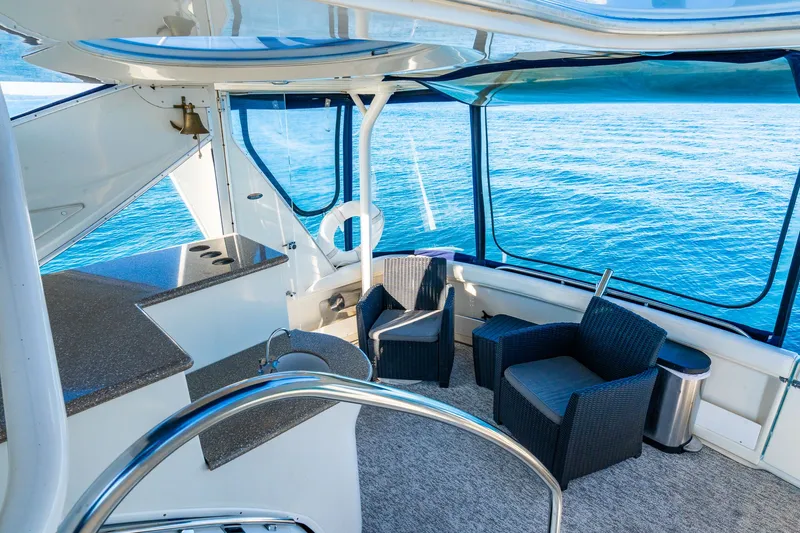 Slide: The Image of 1999 Maxum 4100 SCA Motor Yacht interior with seating and ocean view. - 25