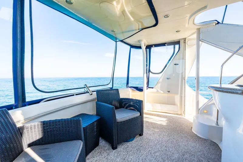 Slide: The Image of Interior of 1999 Maxum 4100 SCA Motor Yacht with ocean view and seating area. - 28