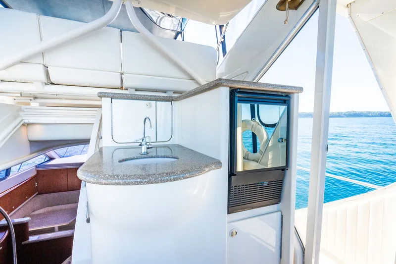 Slide: The Image of 1999 Maxum 4100 SCA Motor Yacht interior with sink and ocean view. - 29