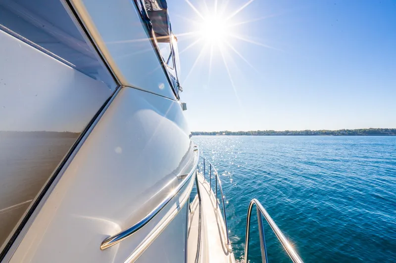 Slide: The Image of 1999 Maxum 4100 SCA Motor Yacht cruising on sunny, blue waters. - 30