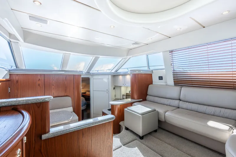 Slide: The Image of Luxurious interior of 1999 Maxum 4100 SCA Motor Yacht with modern furnishings and ample natural light. - 35