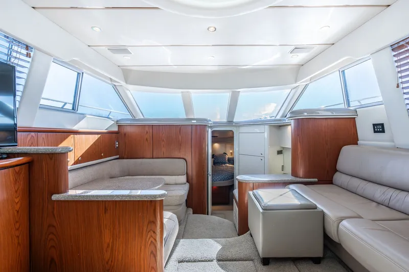 Slide: The Image of Luxurious interior of 1999 Maxum 4100 SCA Motor Yacht with plush seating and wood accents. - 38
