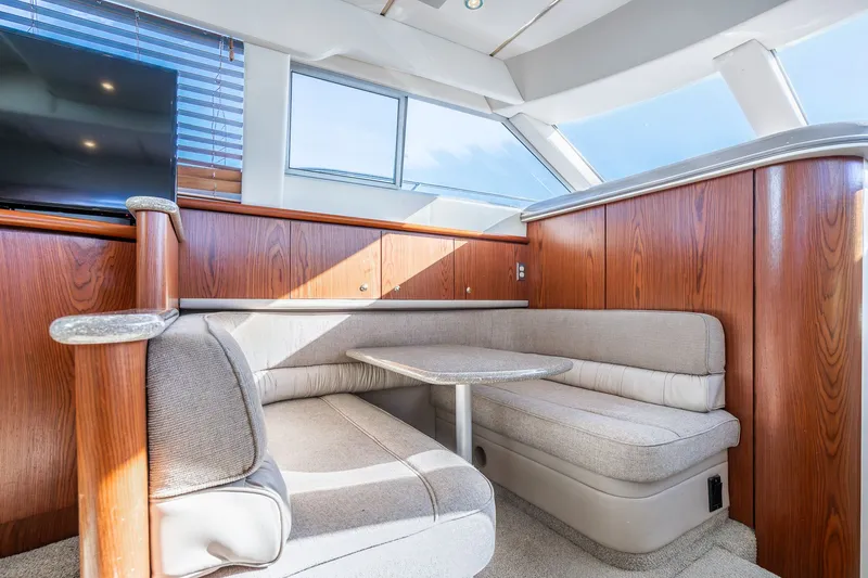 Slide: The Image of Luxurious interior of 1999 Maxum 4100 SCA Motor Yacht with cozy seating and elegant wood finish. - 39