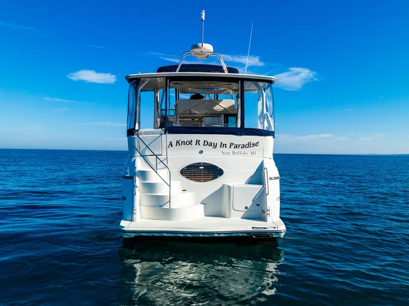 Slide: The Image of 1999 Maxum 4100 SCA Motor Yacht on open water, clear blue sky. - 4