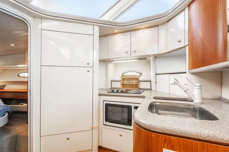 Slide: The Image of Interior of 1999 Maxum 4100 SCA Motor Yacht kitchen with modern amenities. - 41