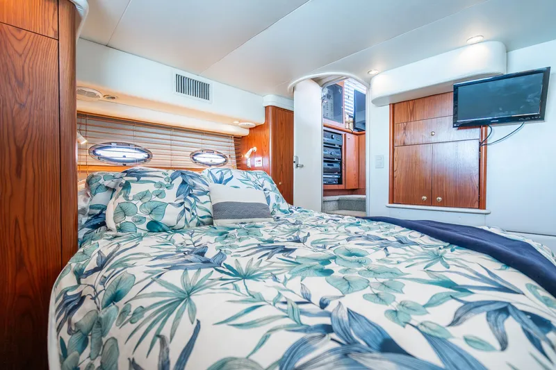 Slide: The Image of Luxurious bedroom interior of 1999 Maxum 4100 SCA Motor Yacht with floral bedding. - 43