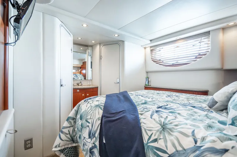 Slide: The Image of Luxurious bedroom interior of 1999 Maxum 4100 SCA Motor Yacht with floral bedding. - 44