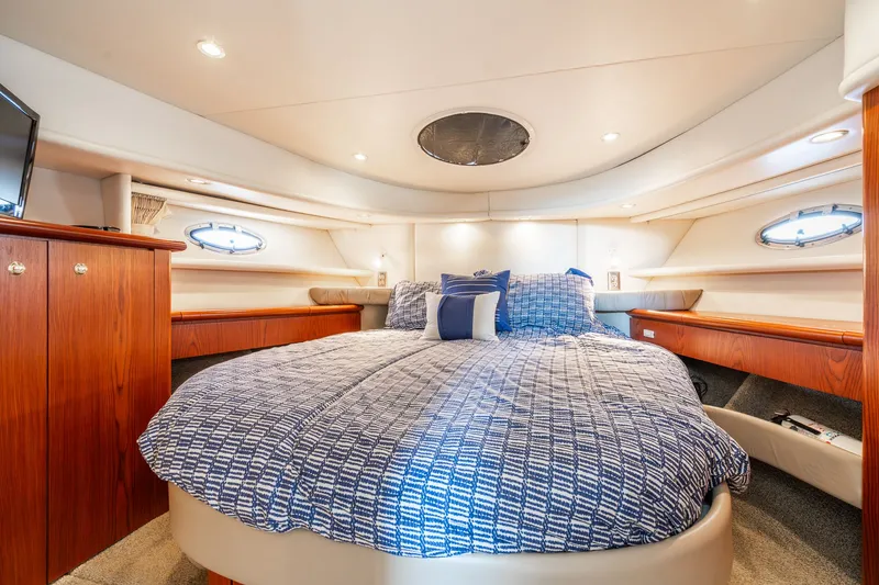 Slide: The Image of Luxurious bedroom in 1999 Maxum 4100 SCA Motor Yacht with cozy bedding and elegant wood accents. - 48