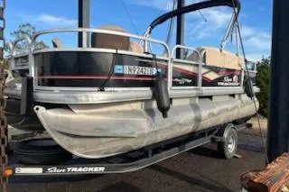 The Image of 2019 Sun Tracker Bass Buggy 18 DLX pontoon boat on trailer, side view. - 0