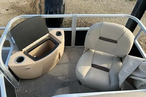 Slide: The Image of 2019 Sun Tracker Bass Buggy 18 DLX interior with beige seating and storage compartment. - 11