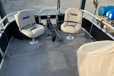 Slide: The Image of 2019 Sun Tracker Bass Buggy 18 DLX pontoon boat interior with seating and steering. - 12