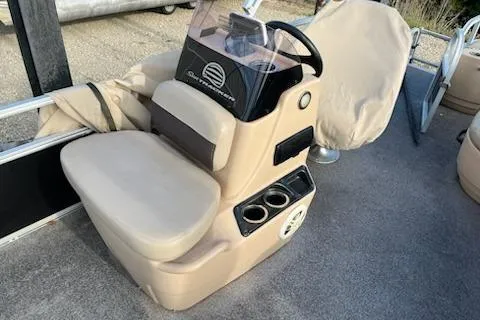 Slide: The Image of 2019 Sun Tracker Bass Buggy 18 DLX boat console with steering wheel and cup holders. - 14