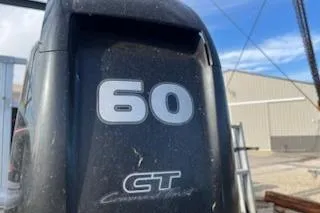 Slide: The Image of 2019 Sun Tracker Bass Buggy 18 DLX with 60 HP engine, outdoor setting. - 8