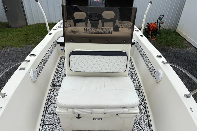 Slide: The Image of 1999 Sea Pro 180 Center Console boat interior with cushioned seating and patterned flooring. - 5