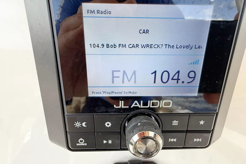 Slide: The Image of Boat stereo system displaying FM radio station 104.9 on a Pioneer 202 Islander. - 17