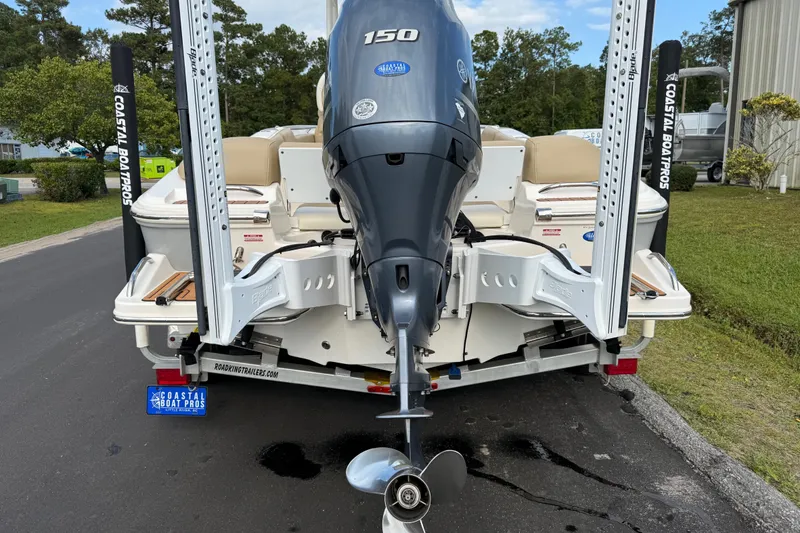 Slide: The Image of 2020 Pioneer 202 Islander boat with Yamaha 150 engine, parked on a trailer. - 19