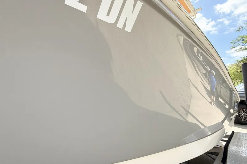Slide: The Image of 2020 Pioneer 202 Islander boat hull reflecting surroundings under clear sky. - 8