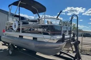 The Image of 2019 Sun Tracker Bass Buggy 16 DLX ET pontoon boat on trailer, sunny day. - 0