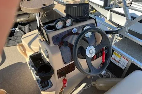 Slide: The Image of 2019 Sun Tracker Bass Buggy 16 DLX ET dashboard with steering wheel and gauges. - 7