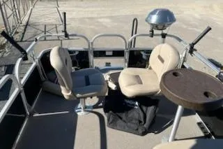 Slide: The Image of 2019 Sun Tracker Bass Buggy 16 DLX ET pontoon boat interior with seating and table. - 9