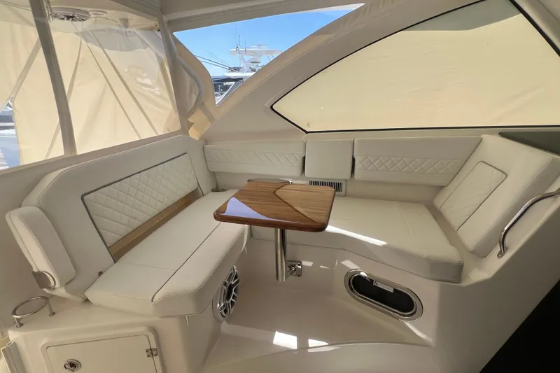 Slide: The Image of Luxurious interior of 2026 Pursuit OS 355 Offshore boat with elegant seating and wooden table. - 15