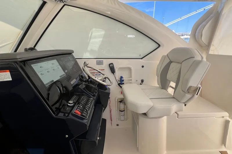 Slide: The Image of 2026 Pursuit OS 355 Offshore helm with modern controls and comfortable seating. - 16