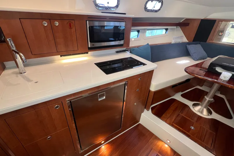 Slide: The Image of Luxurious interior of 2026 Pursuit OS 355 Offshore yacht with modern kitchen and seating area. - 22