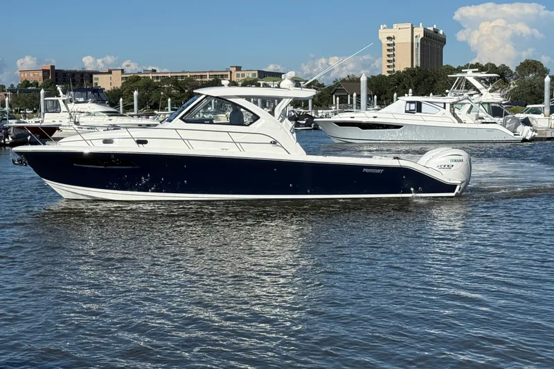 Slide: The Image of 2026 Pursuit OS 355 Offshore boat cruising in a marina with clear skies. - 5