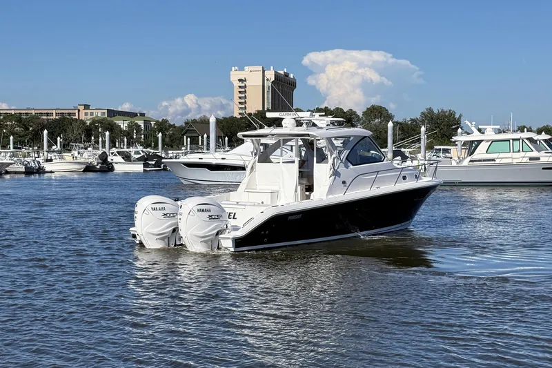 Slide: The Image of 2026 Pursuit OS 355 Offshore boat with twin Yamaha engines in a marina setting. - 8