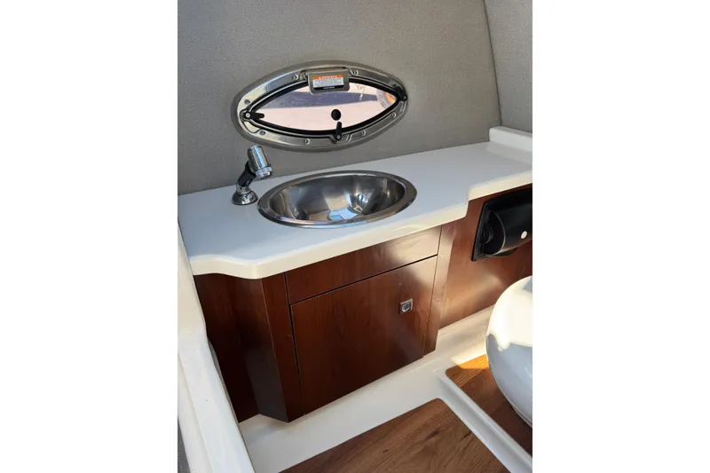 Slide: The Image of 2019 Chaparral 297 SSX boat interior with sink and wooden cabinetry. - 10