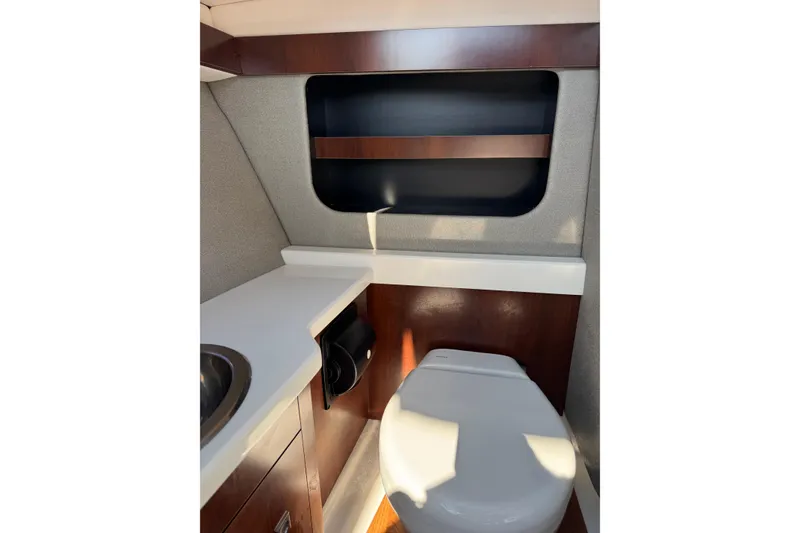 Slide: The Image of 2019 Chaparral 297 SSX boat interior bathroom with toilet and sink. - 11