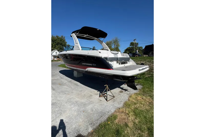 Slide: The Image of 2019 Chaparral 297 SSX boat on land, showcasing sleek design and modern features. - 2