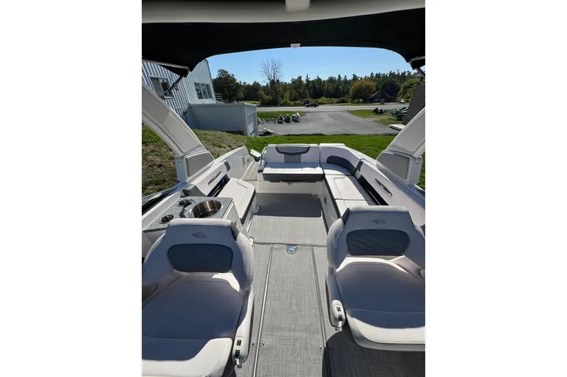 Slide: The Image of 2019 Chaparral 297 SSX boat interior with seating and sink, outdoor setting. - 20