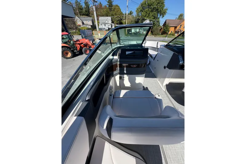 Slide: The Image of 2019 Chaparral 297 SSX boat interior with white seating and dashboard view. - 22