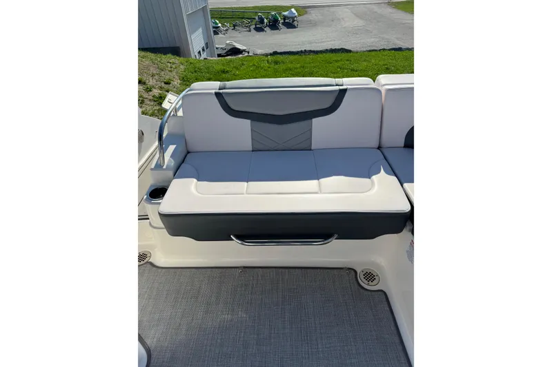 Slide: The Image of 2019 Chaparral 297 SSX boat interior with cushioned seating and cup holder. - 25