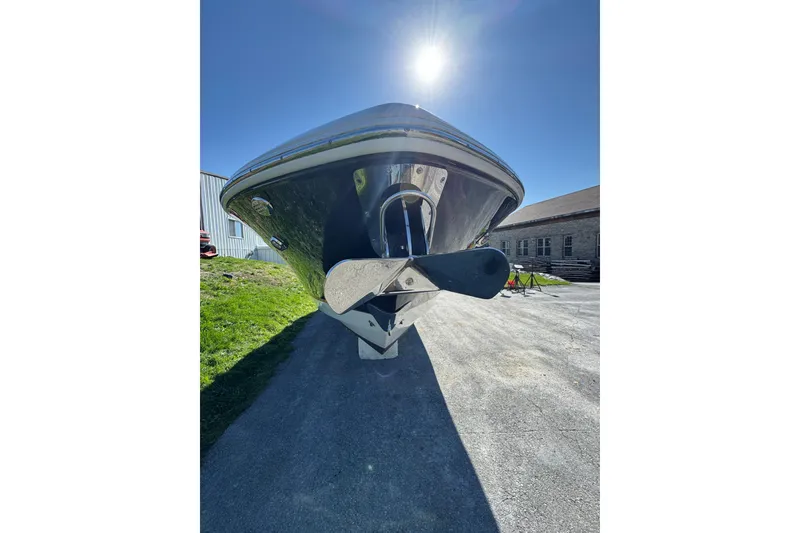 Slide: The Image of 2019 Chaparral 297 SSX boat under bright sun, showcasing sleek hull design. - 4