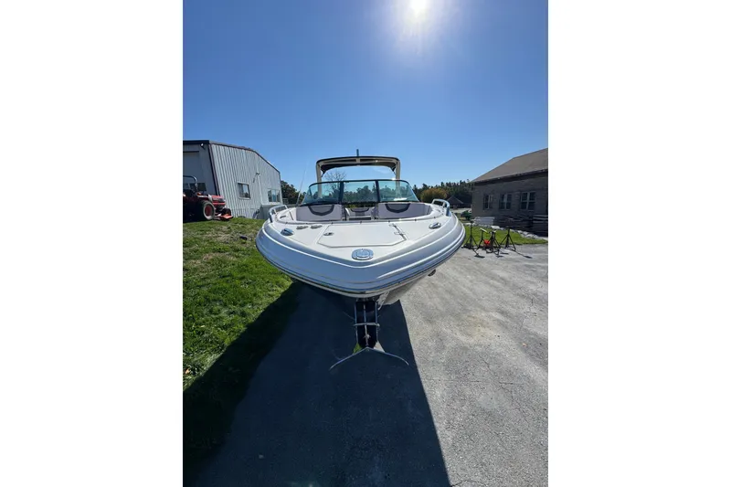 Slide: The Image of 2019 Chaparral 297 SSX boat parked outdoors under clear blue sky. - 5