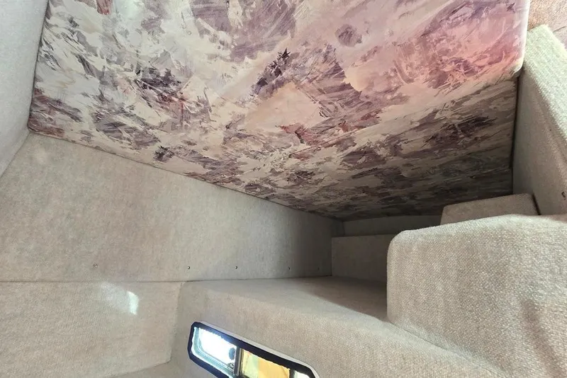 Slide: The Image of Interior cabin of 1997 Sea Ray 240 Sundancer with abstract ceiling design. - 10