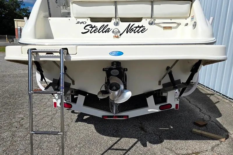 Slide: The Image of 1997 Sea Ray 240 Sundancer boat rear view with ladder and propeller. - 17